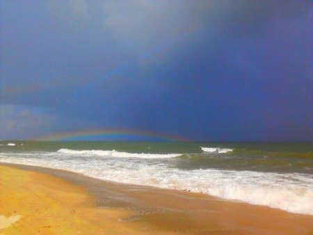 Fish on the Current: Summer is Here Summer storms put on quite a show when you watch them roll in from the beach. A recent squall crept in from the north and the sun from the beach produced a rainbow beneath the front.